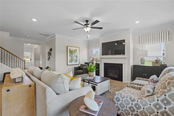 a living room with furniture a fireplace and a flat screen tv
