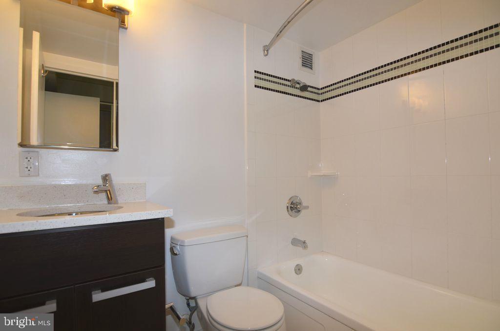 1101 3rd Street Southwest, Unit 305 Washington, DC 20024 - Photo 7 of 15 a bathroom with a sink toilet vanity and shower