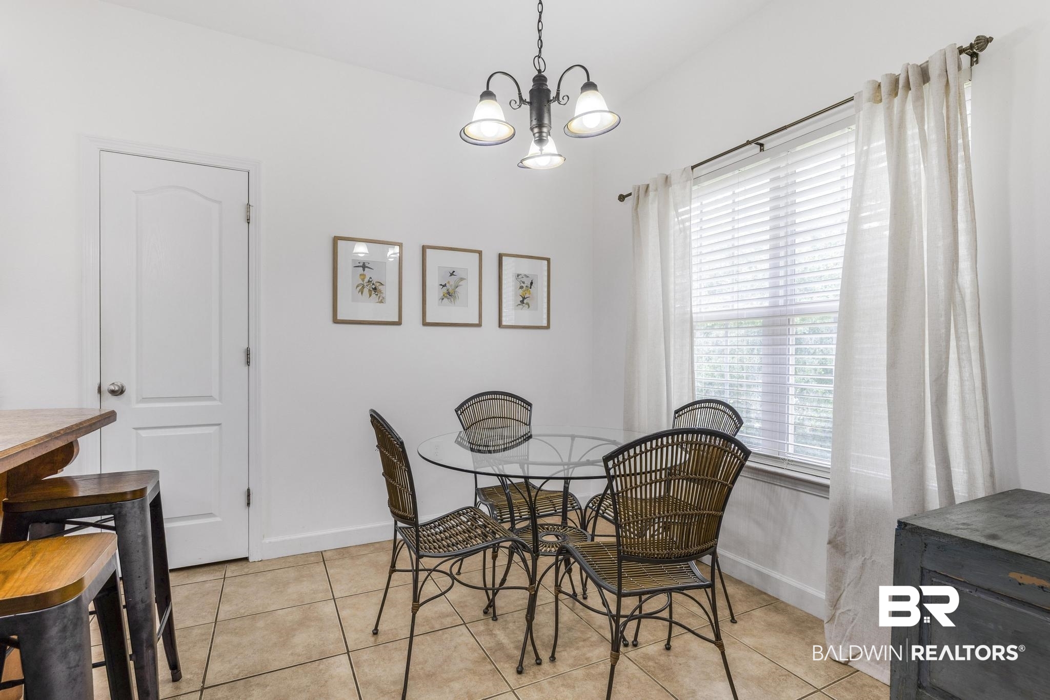 35814 Delvan Lane Bay Minette, AL 36507 - Photo 21 of 53 Dining area featuring a window with blinds and curtains, overhead chandelier lighting, and tile flooring