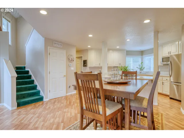 a dining room with furniture and wooden floor