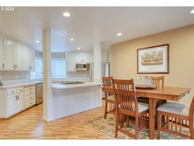 a view of kitchen with cabinets table and chairs