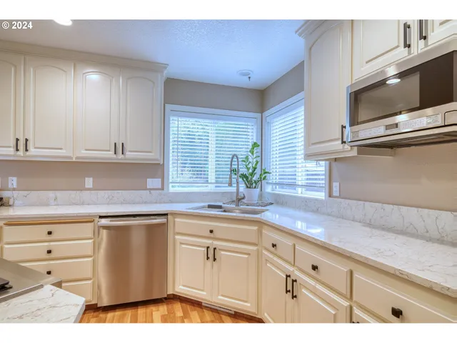a kitchen with granite countertop a sink and cabinets