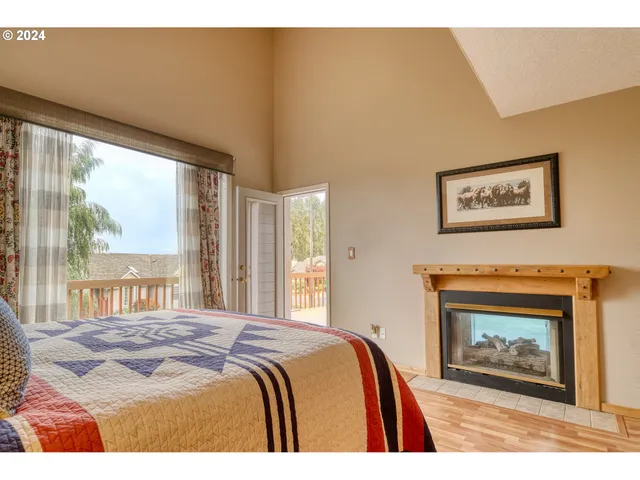 a bedroom with a bed and a painting on the wall