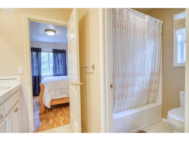 a en suite bathroom with a sink double vanity and a mirror