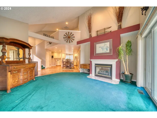 a view of a kitchen with refrigerator a microwave and a fireplace
