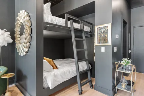 a bedroom with a bed and a chandelier