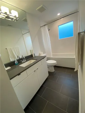 a spacious bathroom with a double vanity sink a mirror and a shower
