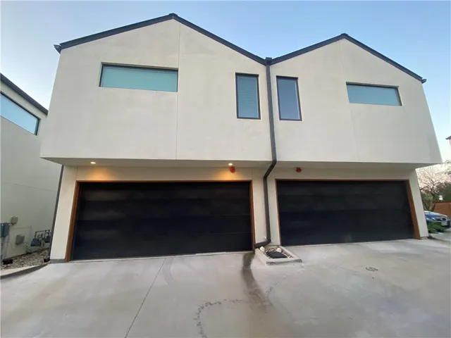 an aerial view of multiple houses with yard