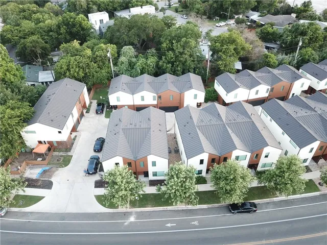a view of a lake with a yard and large trees