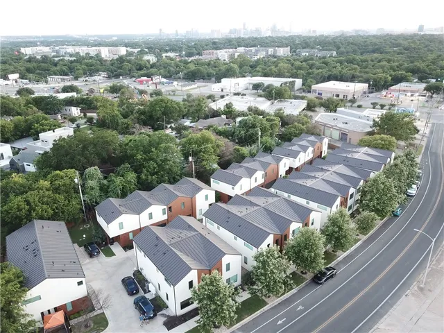 an aerial view of residential houses with outdoor space