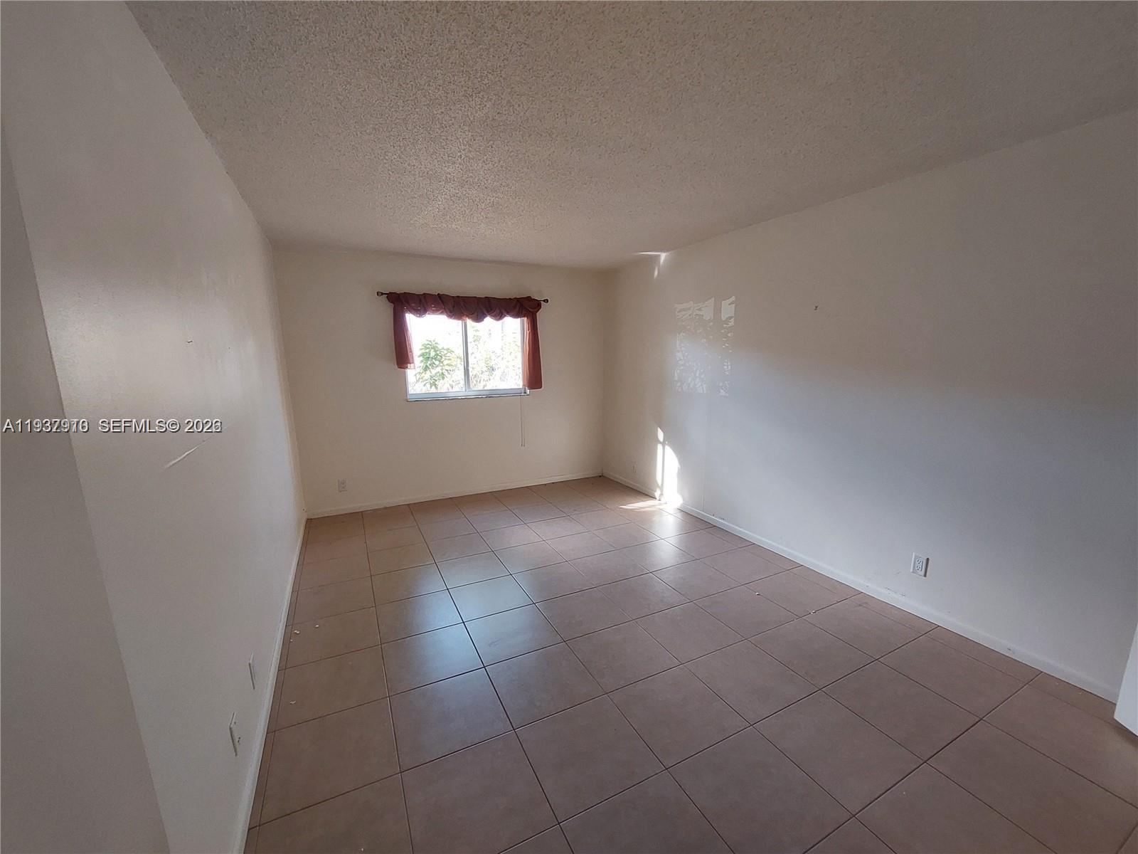 253 South Cypress Road, Unit 206 Pompano Beach, FL 33060 - Photo 14 of 30 an empty room with windows