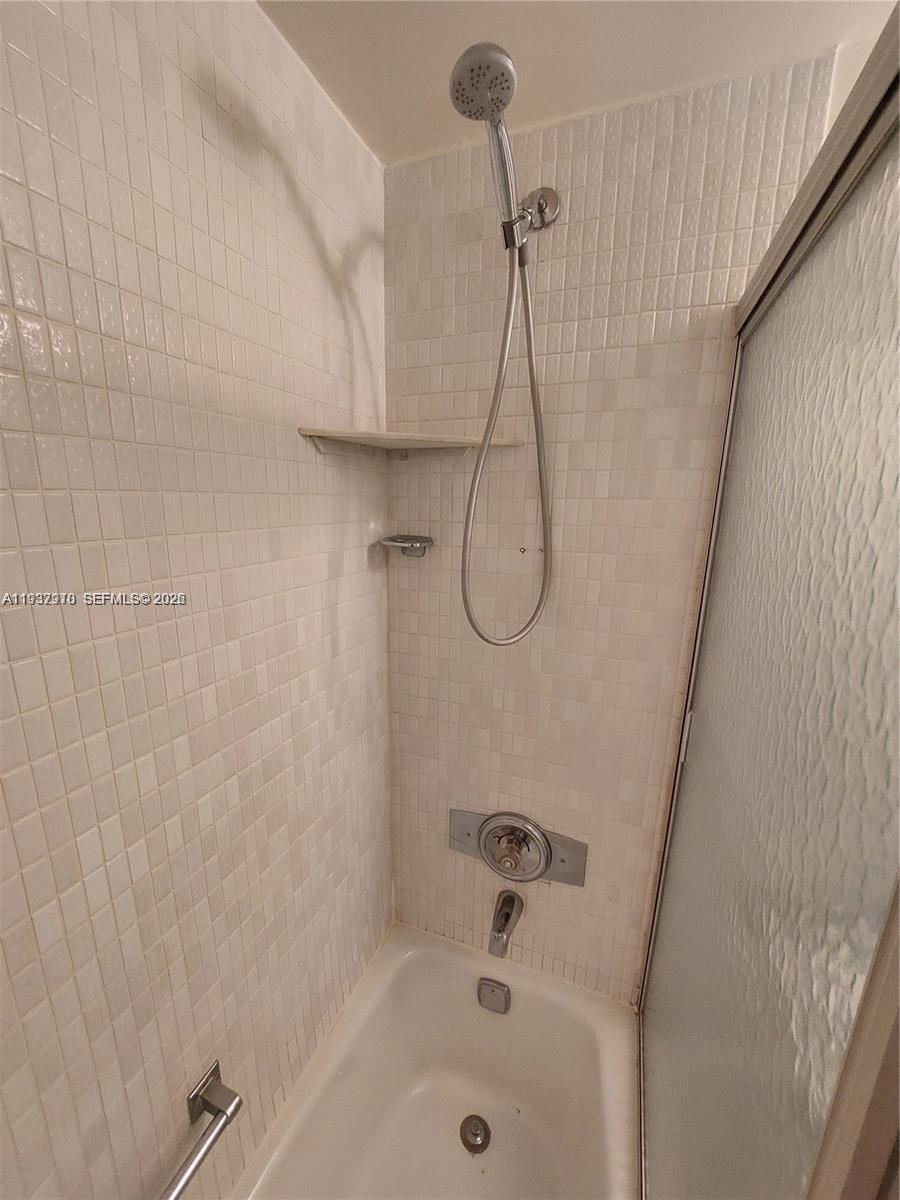253 South Cypress Road, Unit 206 Pompano Beach, FL 33060 - Photo 16 of 30 a bathroom with a bath tub and a shower