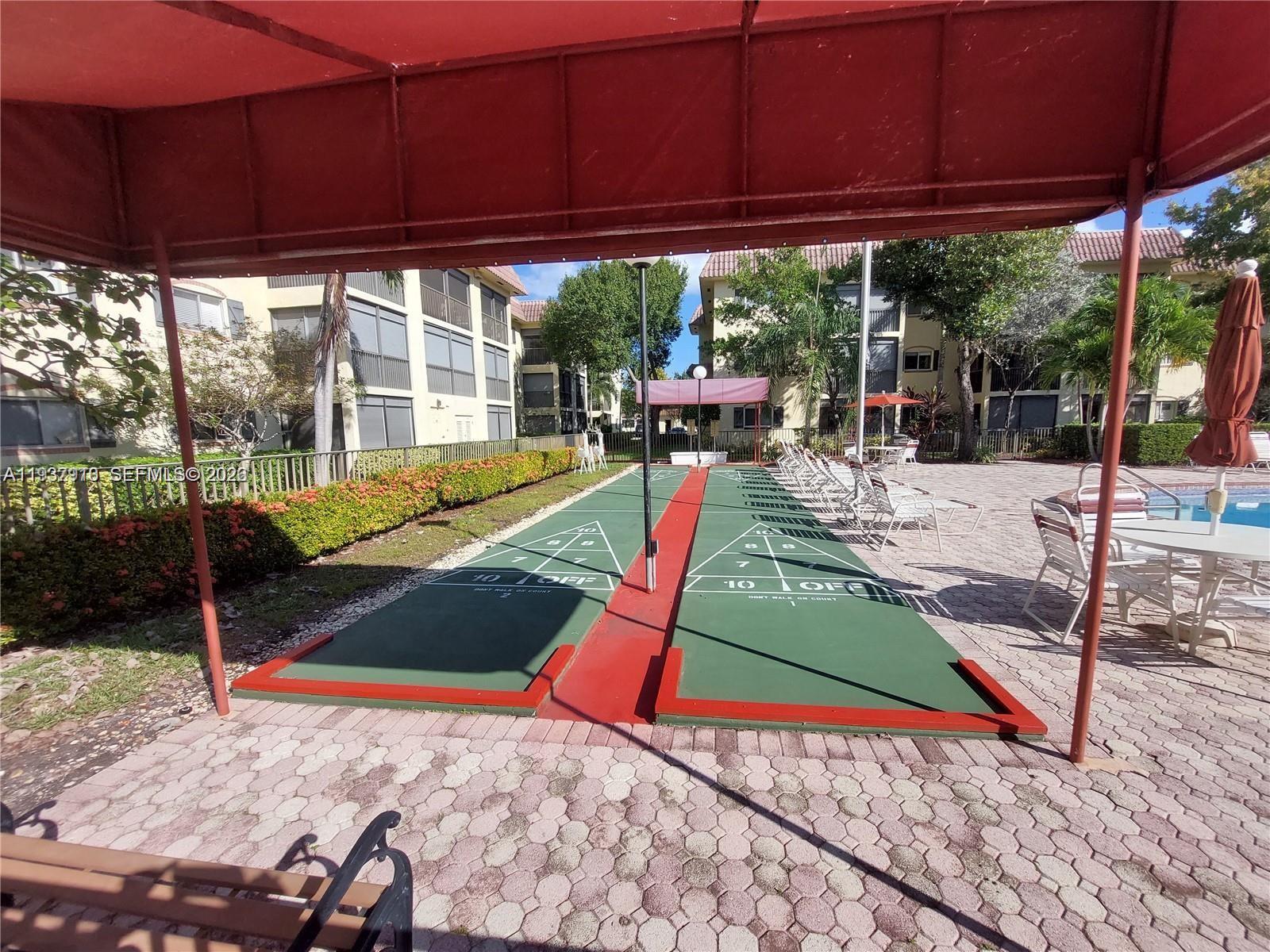 253 South Cypress Road, Unit 206 Pompano Beach, FL 33060 - Photo 22 of 30 a view of a backyard with sitting area