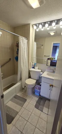 a bedroom with a bed and a mirror