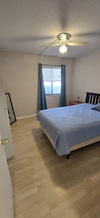 a bedroom with a bed and cabinets