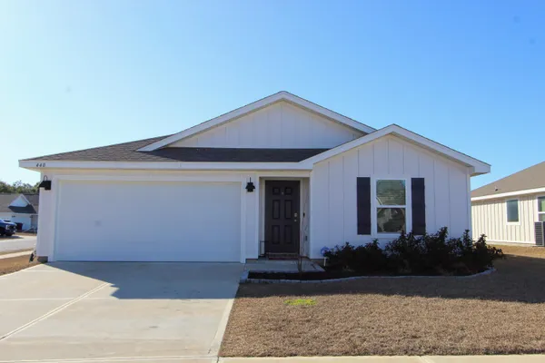 a front view of house with garage and yard