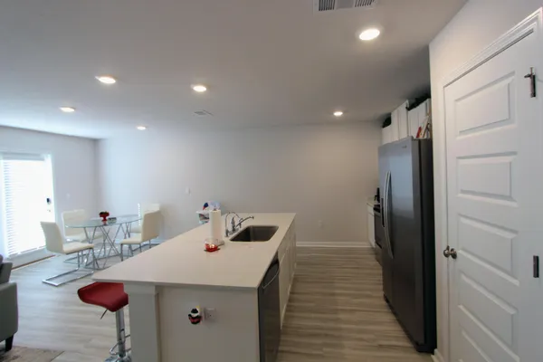 a kitchen with a sink and refrigerator