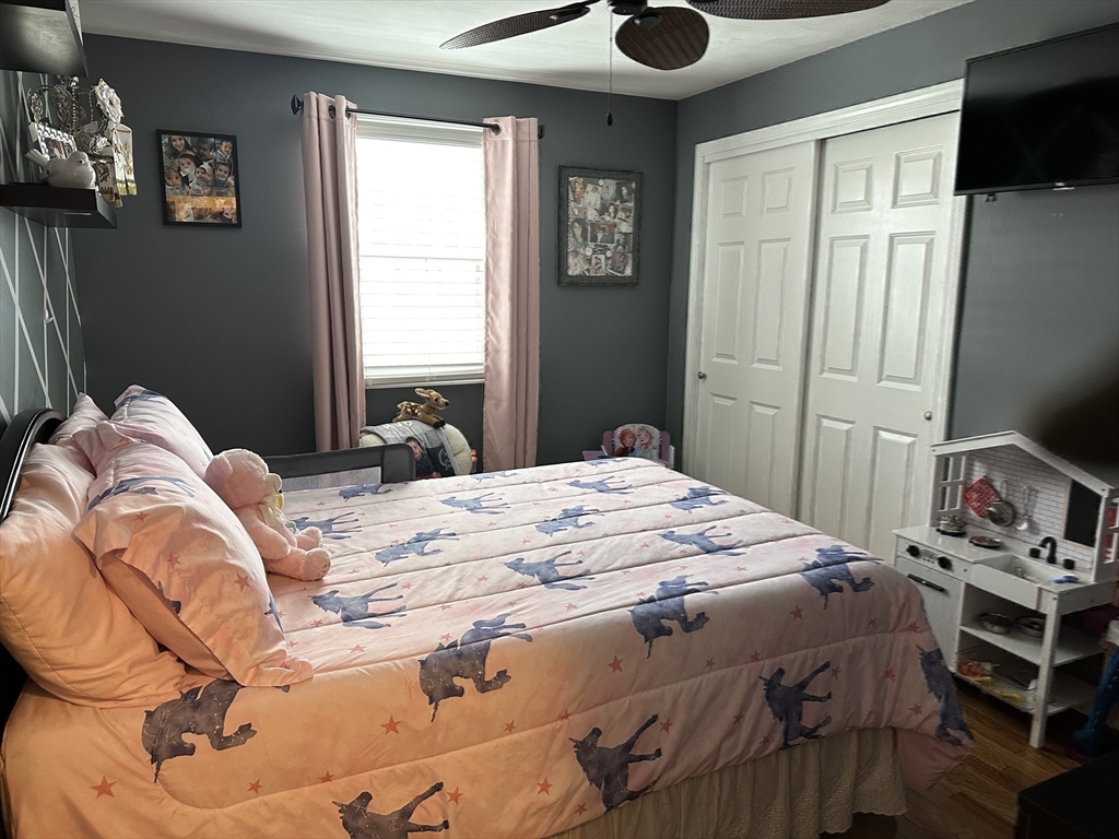 357 Baker Street Fall River, MA 02721 - Photo 13 of 31 a bedroom with a bed and a tv in it