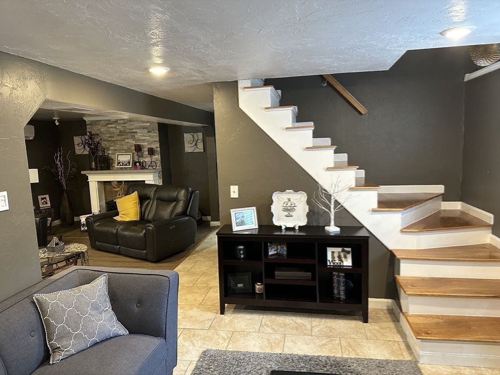 357 Baker Street Fall River, MA 02721 - Photo 15 of 31 a living room with furniture and a fireplace