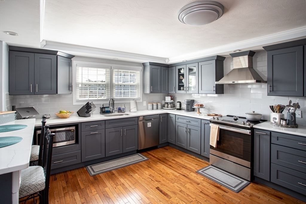 357 Baker Street Fall River, MA 02721 - Photo 5 of 31 a kitchen with stainless steel appliances granite countertop a sink stove and refrigerator