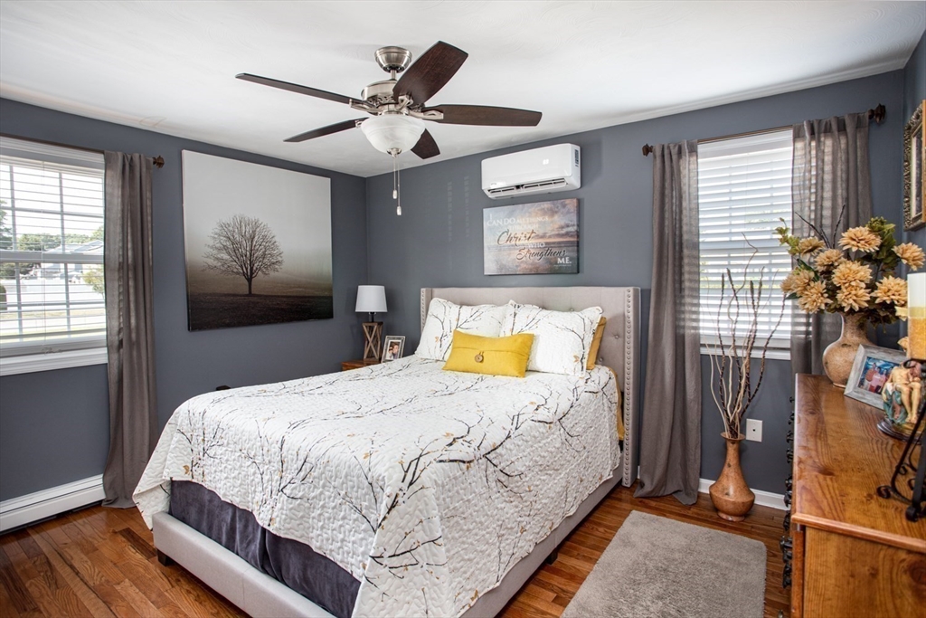 357 Baker Street Fall River, MA 02721 - Photo 10 of 31 a bedroom with a bed and a chandelier