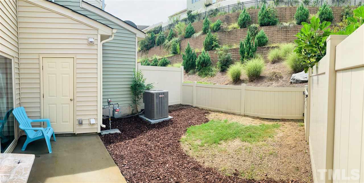 7804 Allscott Way Raleigh, NC 27612 - Photo 14 of 16 a view of a backyard with plants