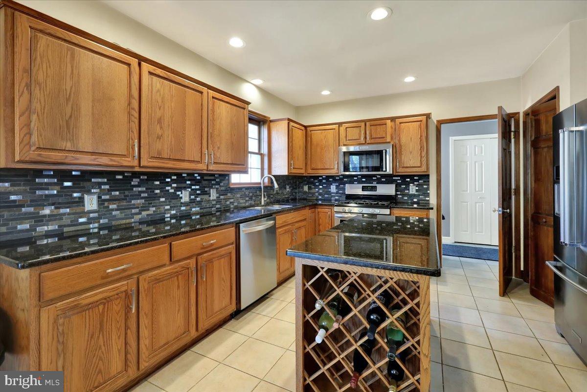 23 Laura Court Sinking Spring, PA 19608 - Photo 14 of 67 a kitchen with stainless steel appliances granite countertop a stove a sink and a refrigerator