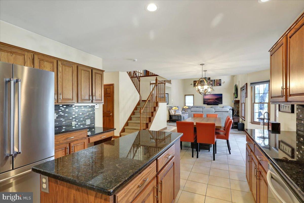 23 Laura Court Sinking Spring, PA 19608 - Photo 17 of 67 a kitchen with stainless steel appliances granite countertop a sink a stove and a refrigerator