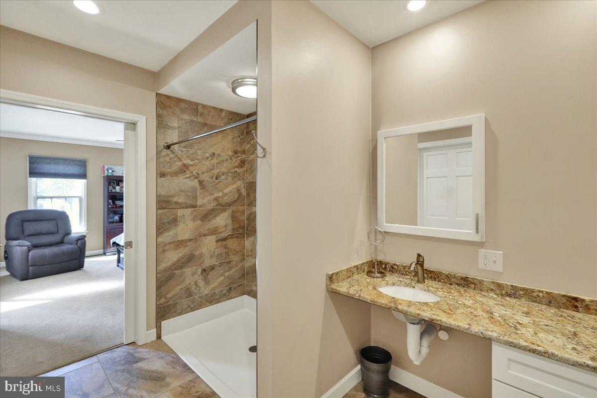 23 Laura Court Sinking Spring, PA 19608 - Photo 24 of 67 a bathroom with a granite countertop sink and a mirror