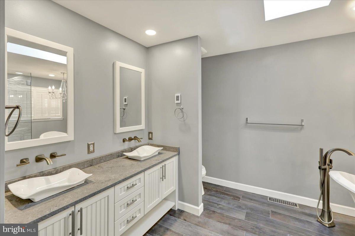 23 Laura Court Sinking Spring, PA 19608 - Photo 36 of 67 a bathroom with a granite countertop sink and a mirror