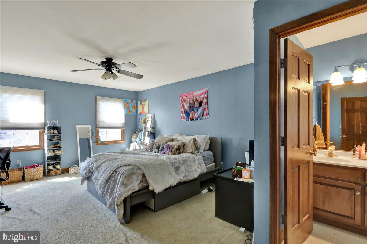 23 Laura Court Sinking Spring, PA 19608 - Photo 44 of 67 a bedroom with a bed and a chandelier