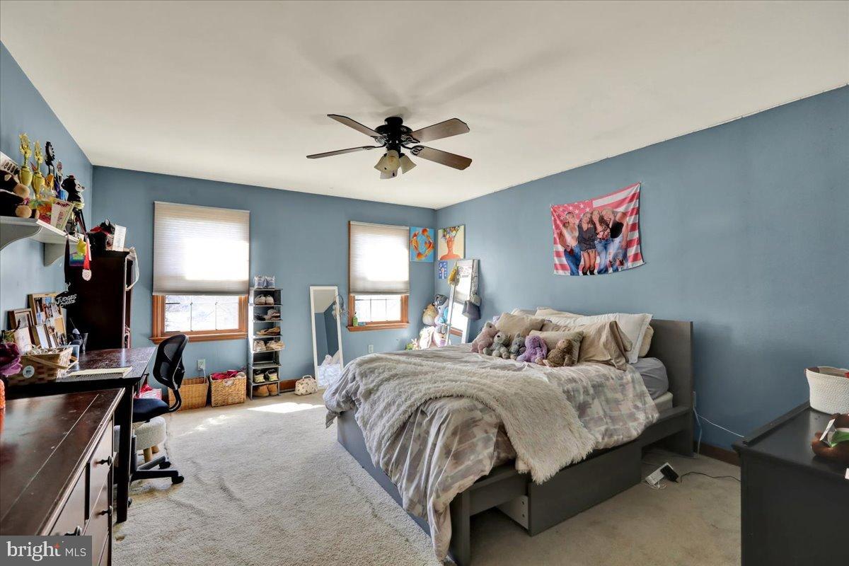 23 Laura Court Sinking Spring, PA 19608 - Photo 48 of 67 a bedroom with a bed and a chandelier