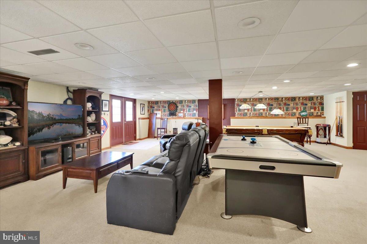 23 Laura Court Sinking Spring, PA 19608 - Photo 49 of 67 a living room with furniture a flat screen tv and a counter
