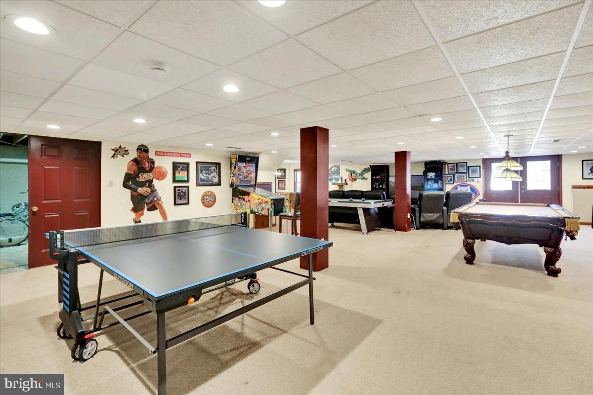 23 Laura Court Sinking Spring, PA 19608 - Photo 52 of 67 a living room with furniture a table and a flat screen tv