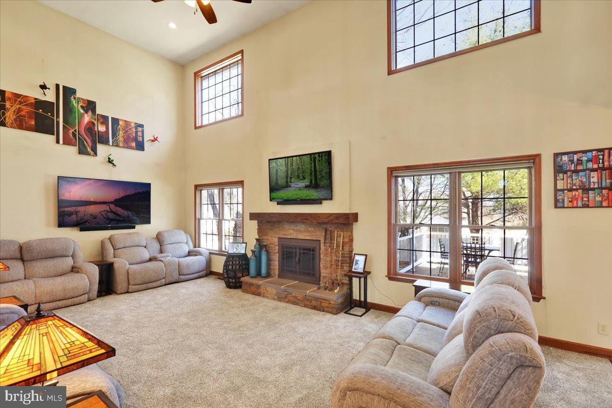 23 Laura Court Sinking Spring, PA 19608 - Photo 9 of 67 a living room with furniture a flat screen tv and a fireplace