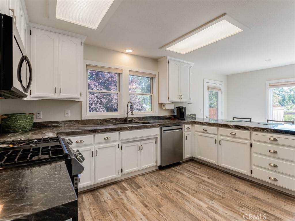 8370 Prado Lane Atascadero, CA 93422 - Photo 14 of 54 a kitchen with granite countertop a sink cabinets stainless steel appliances and a window