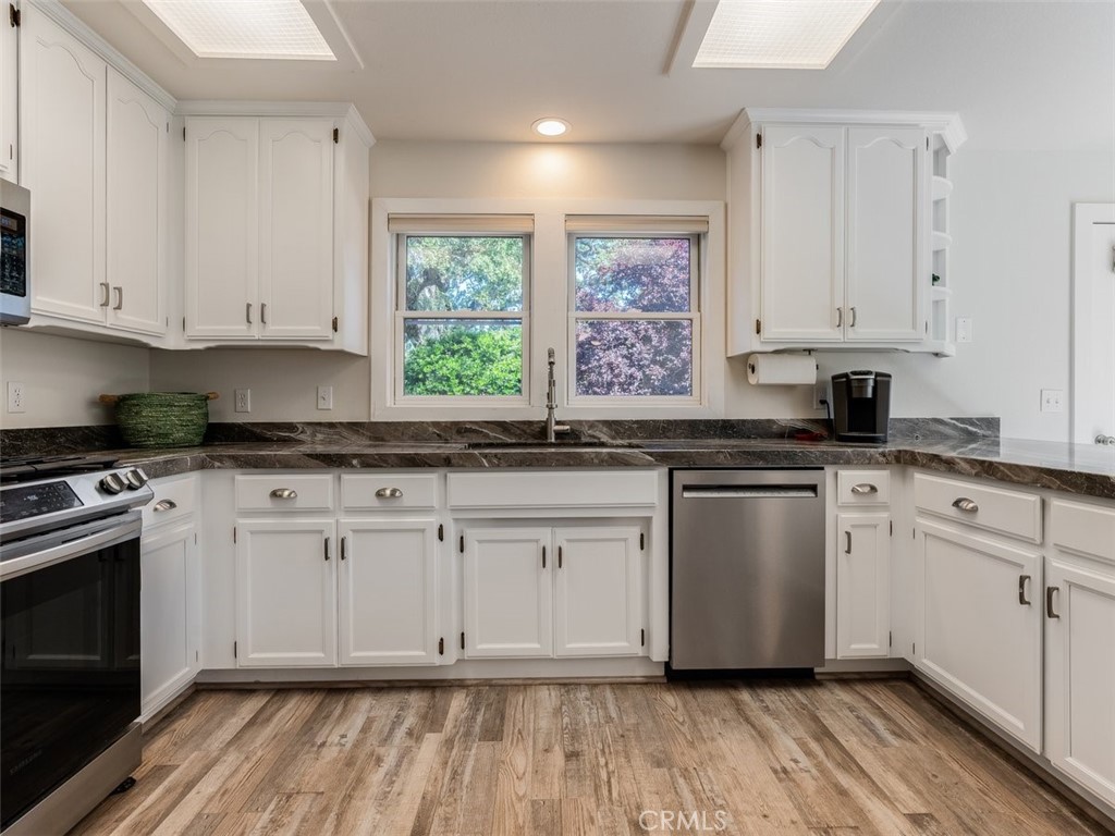 8370 Prado Lane Atascadero, CA 93422 - Photo 17 of 54 a kitchen with granite countertop white cabinets and white appliances
