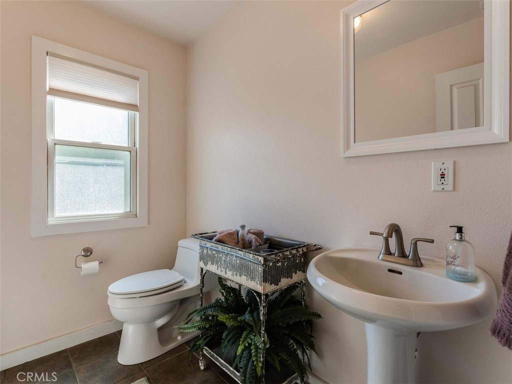 8370 Prado Lane Atascadero, CA 93422 - Photo 20 of 54 a bathroom with a sink toilet and a mirror