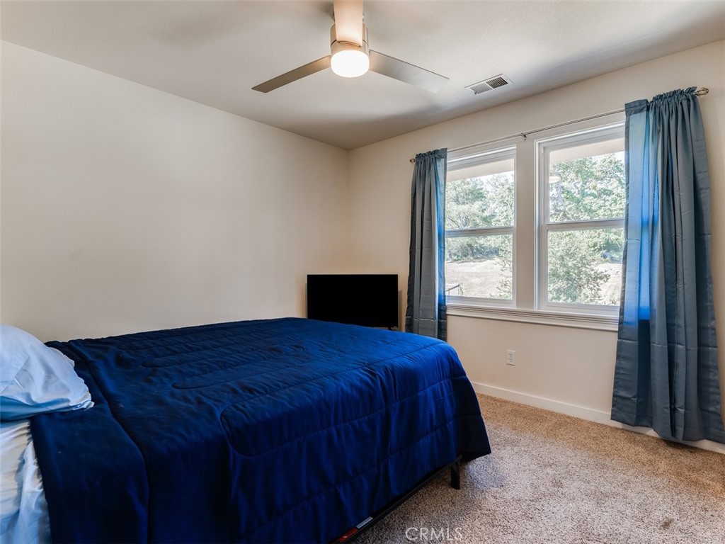 8370 Prado Lane Atascadero, CA 93422 - Photo 23 of 54 a bedroom with a bed and a window