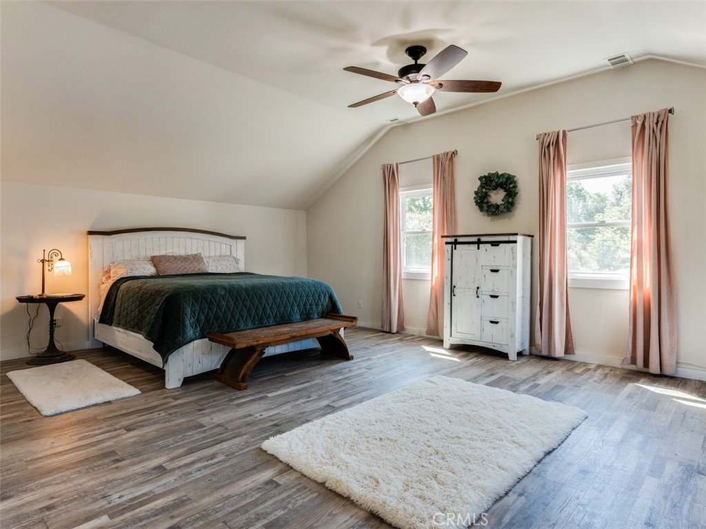 8370 Prado Lane Atascadero, CA 93422 - Photo 27 of 54 a bedroom with a bed and a chandelier