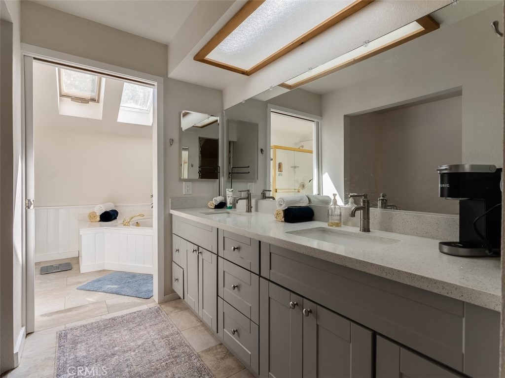 8370 Prado Lane Atascadero, CA 93422 - Photo 31 of 54 a spacious bathroom with a double vanity sink a mirror and a shower