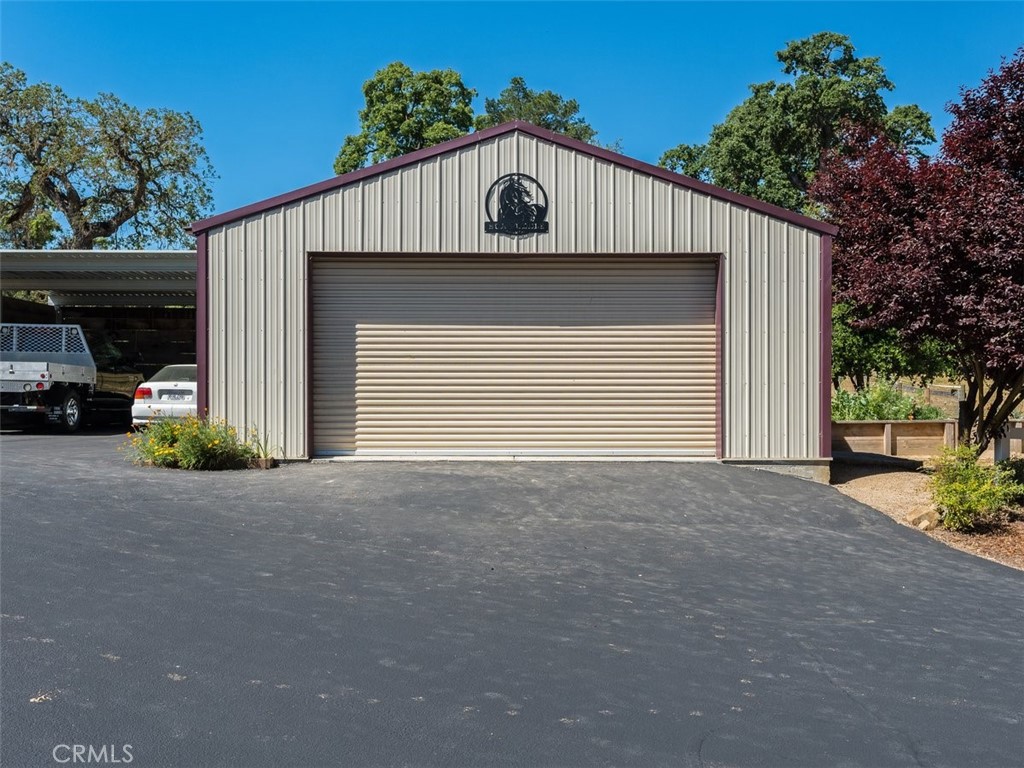 8370 Prado Lane Atascadero, CA 93422 - Photo 42 of 54 a front view of a house with a yard and garage