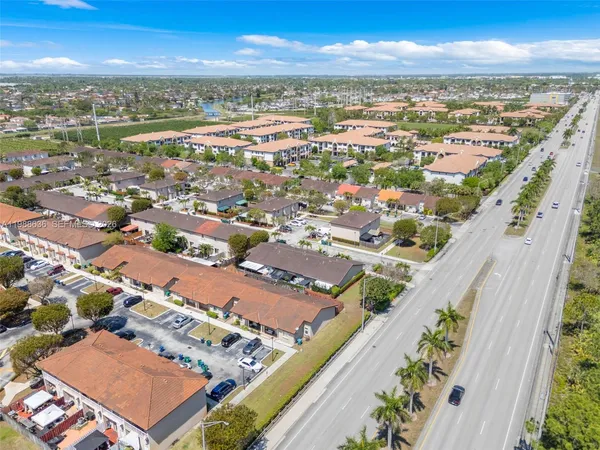 an aerial view of residential houses with outdoor space