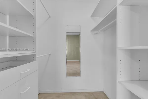 a room with a cabinets and a window