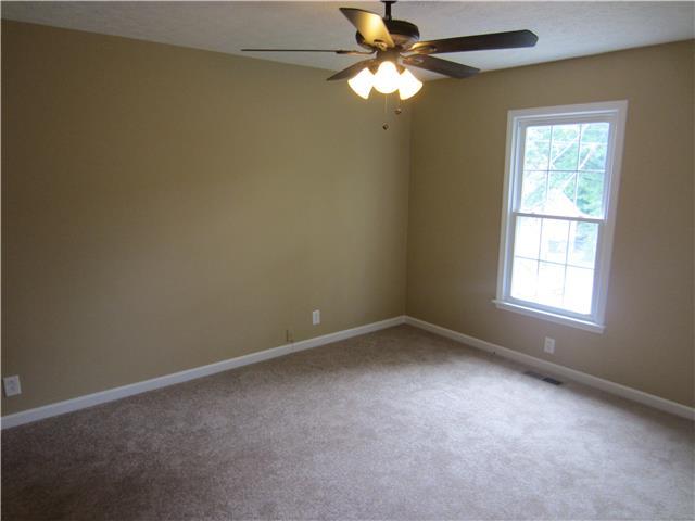 828 Bishopsgate Road Antioch, TN 37013 - Photo 7 of 14 an empty room with a window and a fan