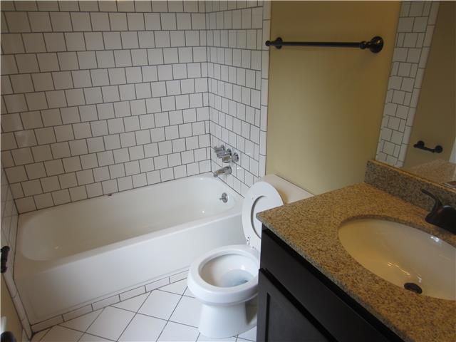 828 Bishopsgate Road Antioch, TN 37013 - Photo 8 of 14 a bathroom with a granite countertop toilet sink and mirror