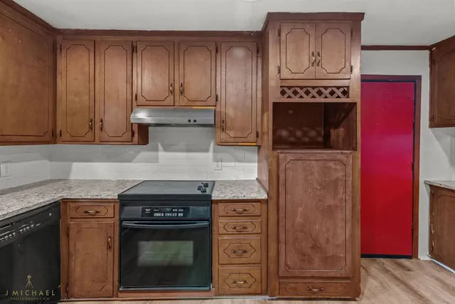a kitchen with stainless steel appliances granite countertop a stove and a microwave