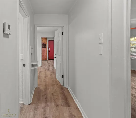 a view of a hallway with wooden floor