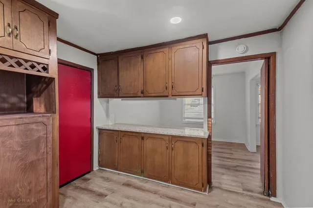 a kitchen with wooden cabinets and a refrigerator