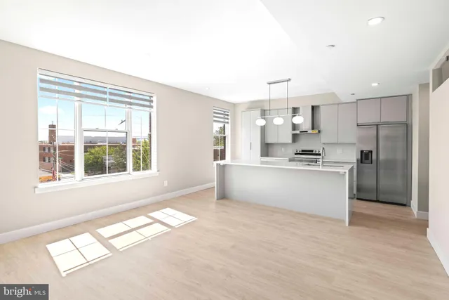 a large kitchen with kitchen island a window stainless steel appliances and cabinets